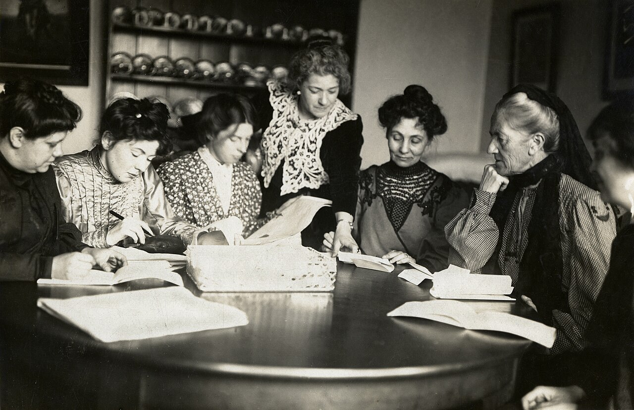 Women gather round a table at the union's first meeting