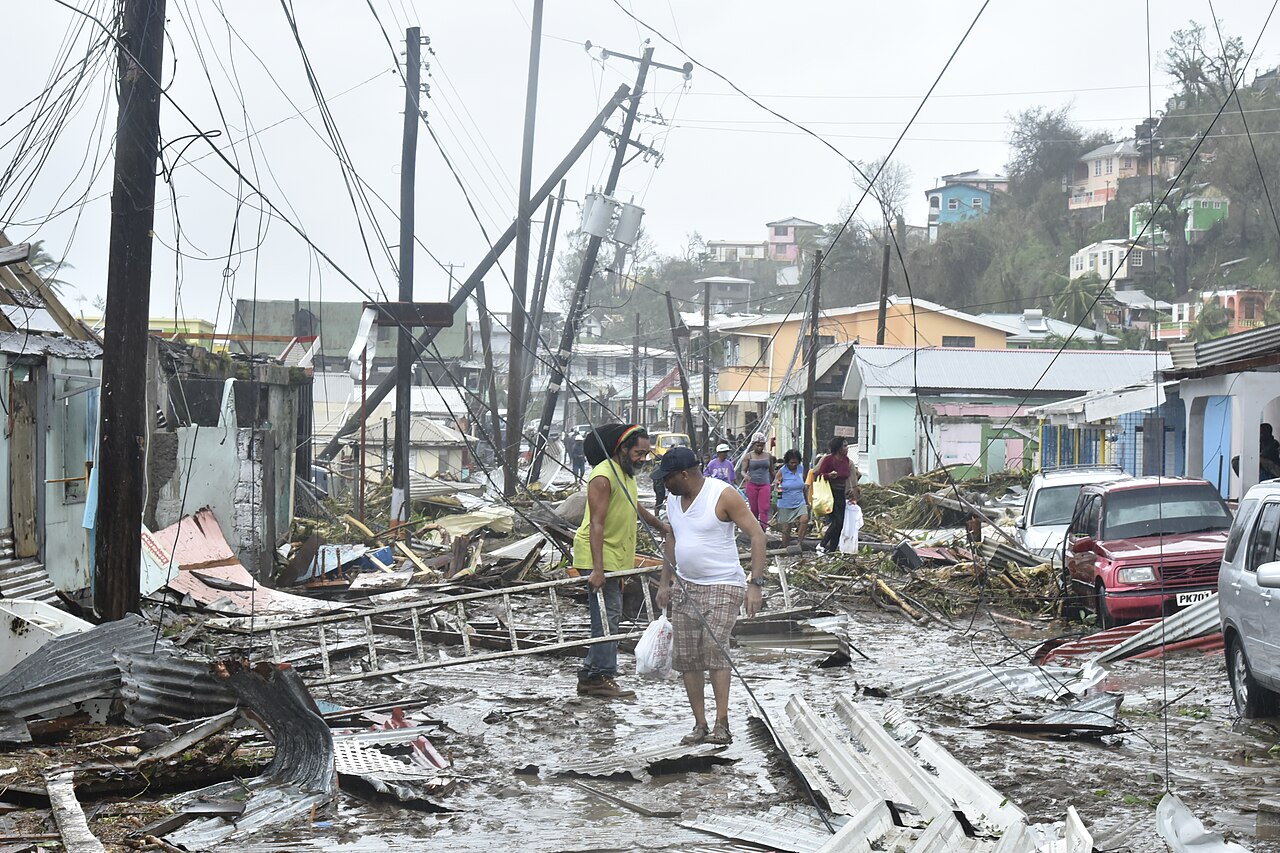 Residents walk through debris-strewn streets after the hurricane