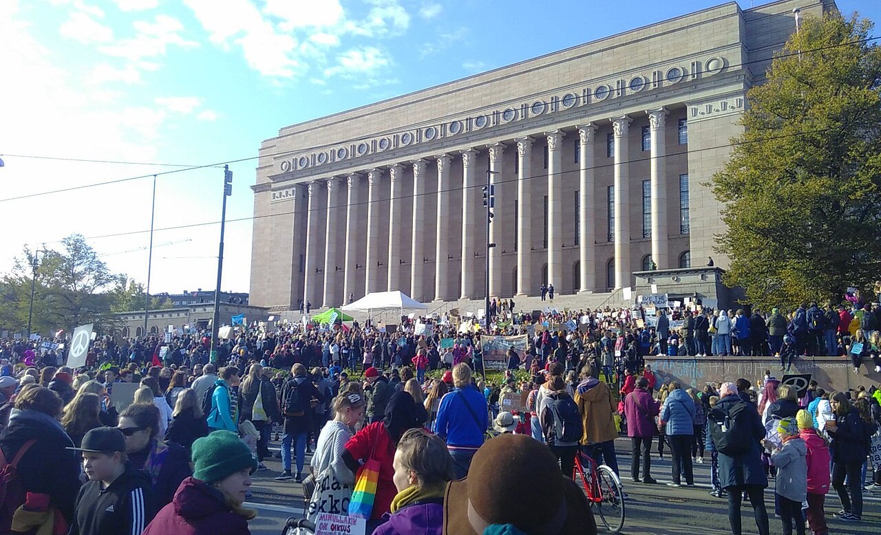 Demonstrators gather outside the Finnish Parliament House in Helsinki