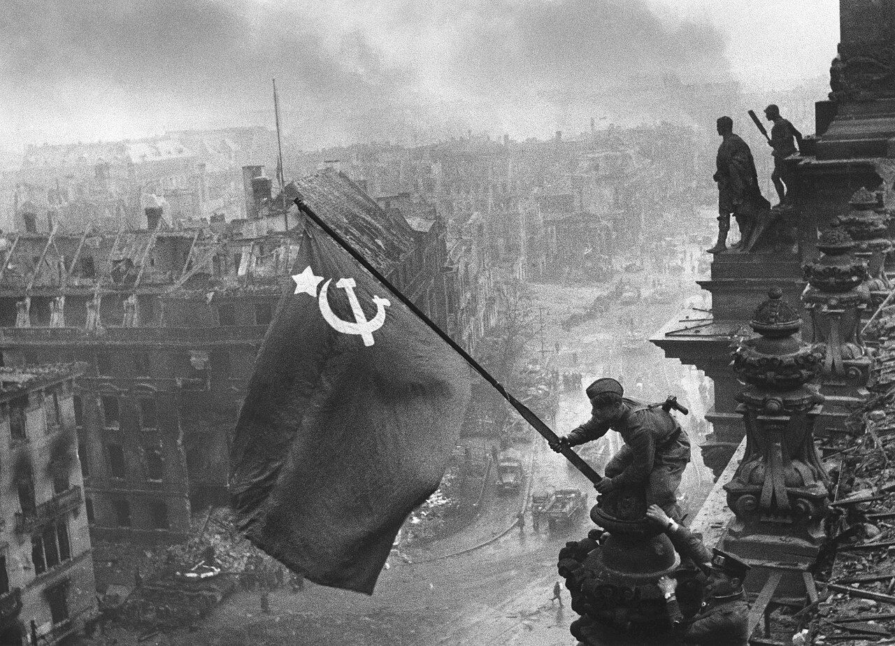 Soviet soldiers hoist the red flag over the Reichstag in Berlin