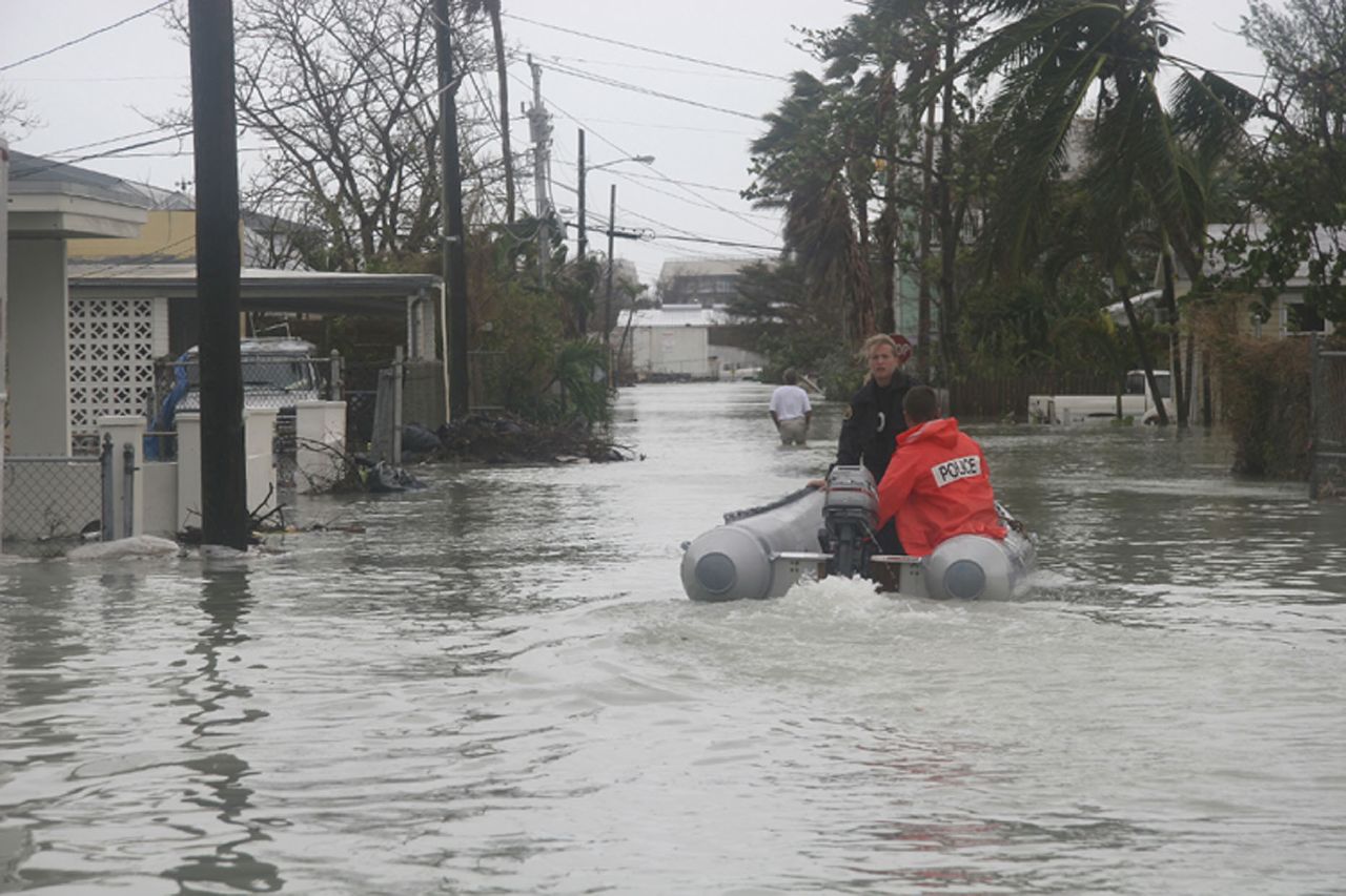 Rescue workers navigate a flooded street in an inflatable boat
