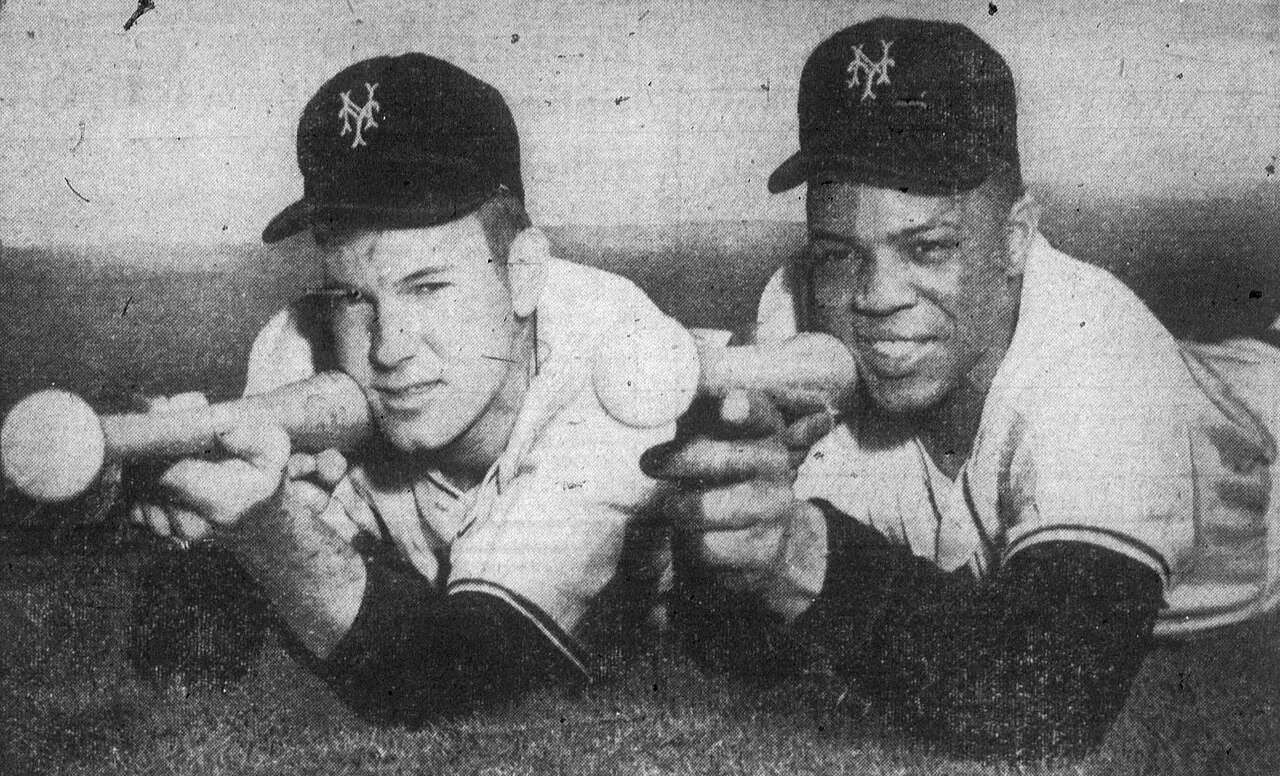 Willie Mays and a teammate pose with bats in spring training