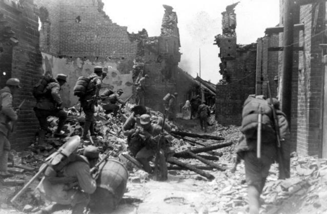 Marines advance through rubble during fighting for Henderson Field