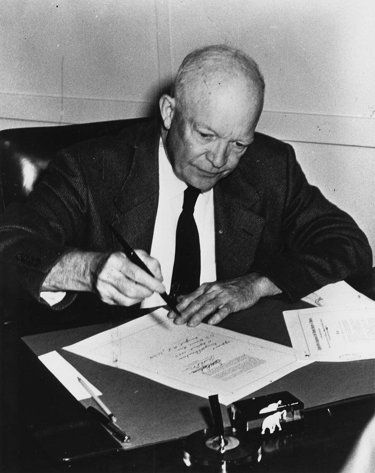 President Eisenhower signs the Civil Rights Act at his desk