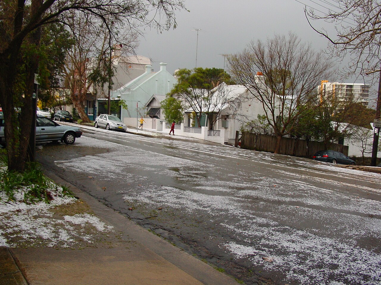 A Sydney street blanketed in hail following the costliest natural disaster in Australian history