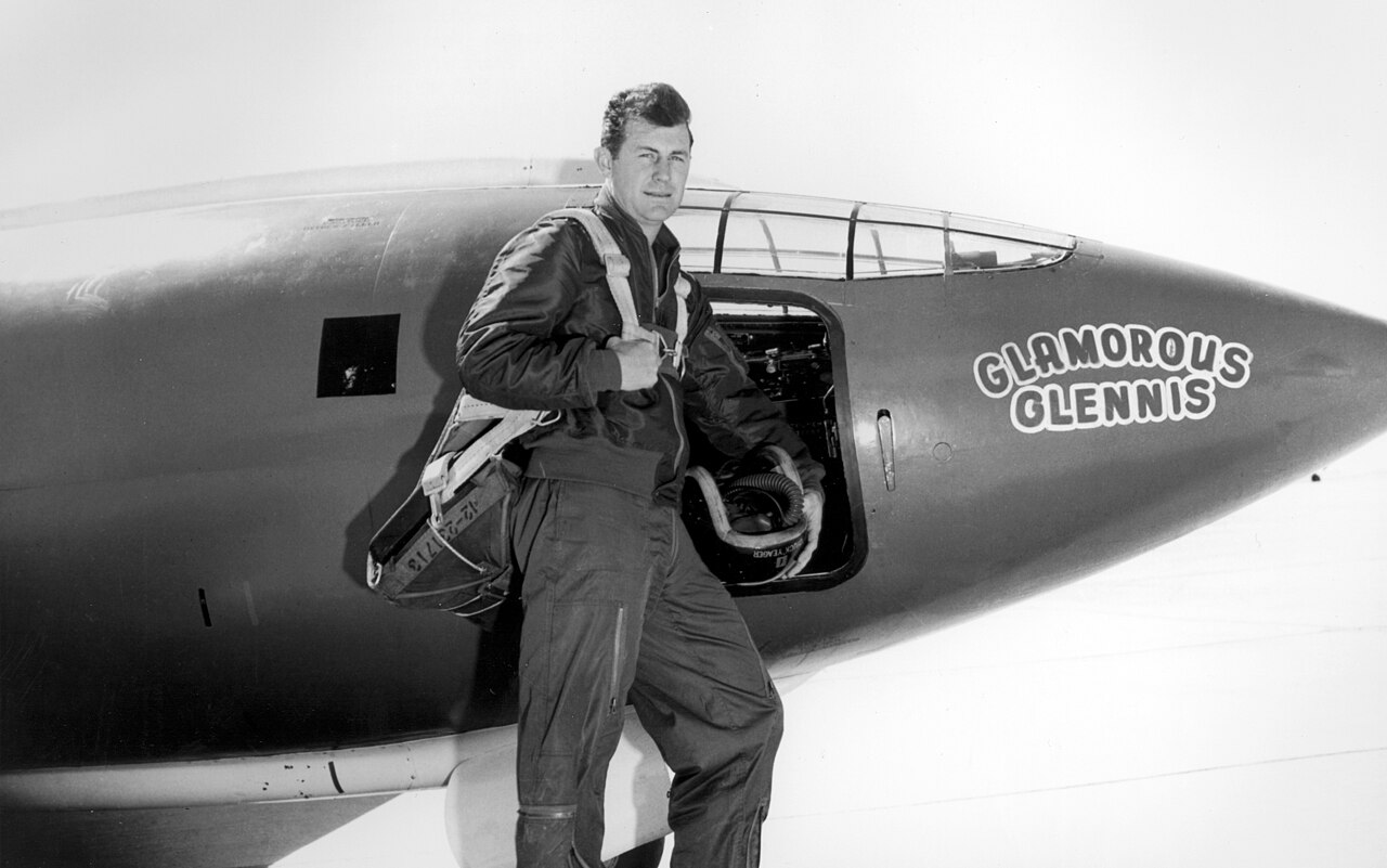 The test pilot stands beside the rocket plane before his record-breaking flight