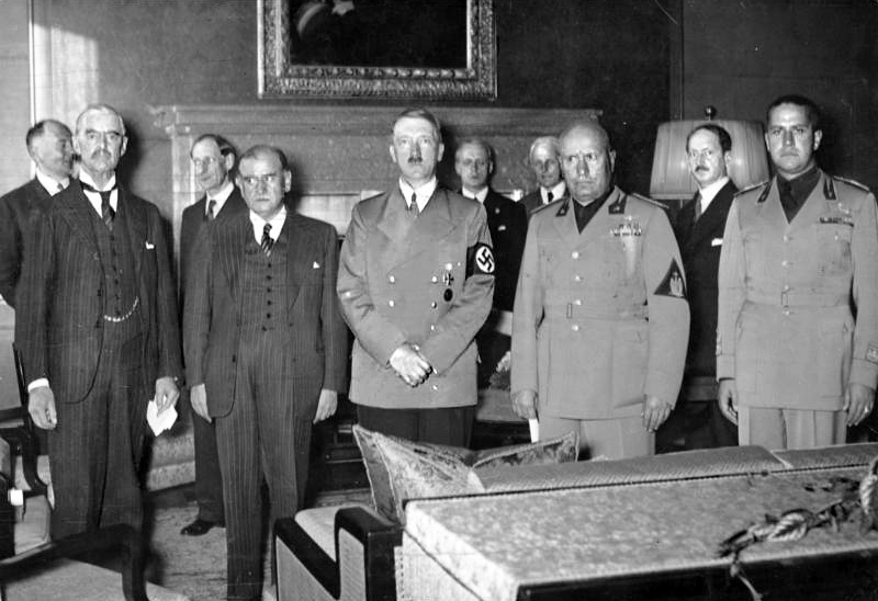 Hitler, Chamberlain, Mussolini and Daladier stand in the Munich conference room after signing the agreement