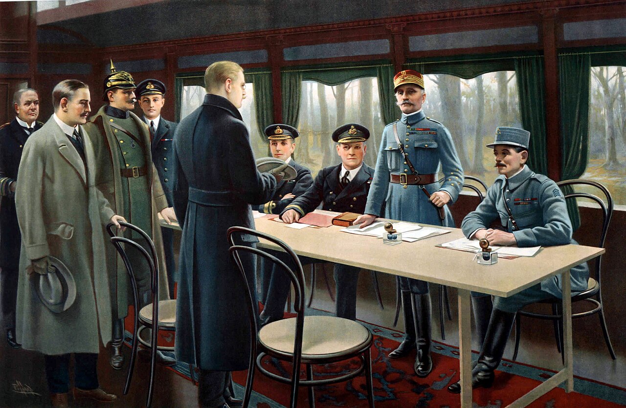 German and Allied officers sign the armistice in a railway carriage at Compiègne