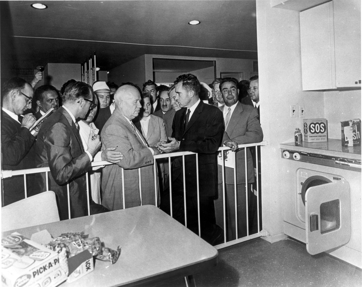 Nikita Khrushchev and Richard Nixon debate Cold War ideologies at the American National Exhibition