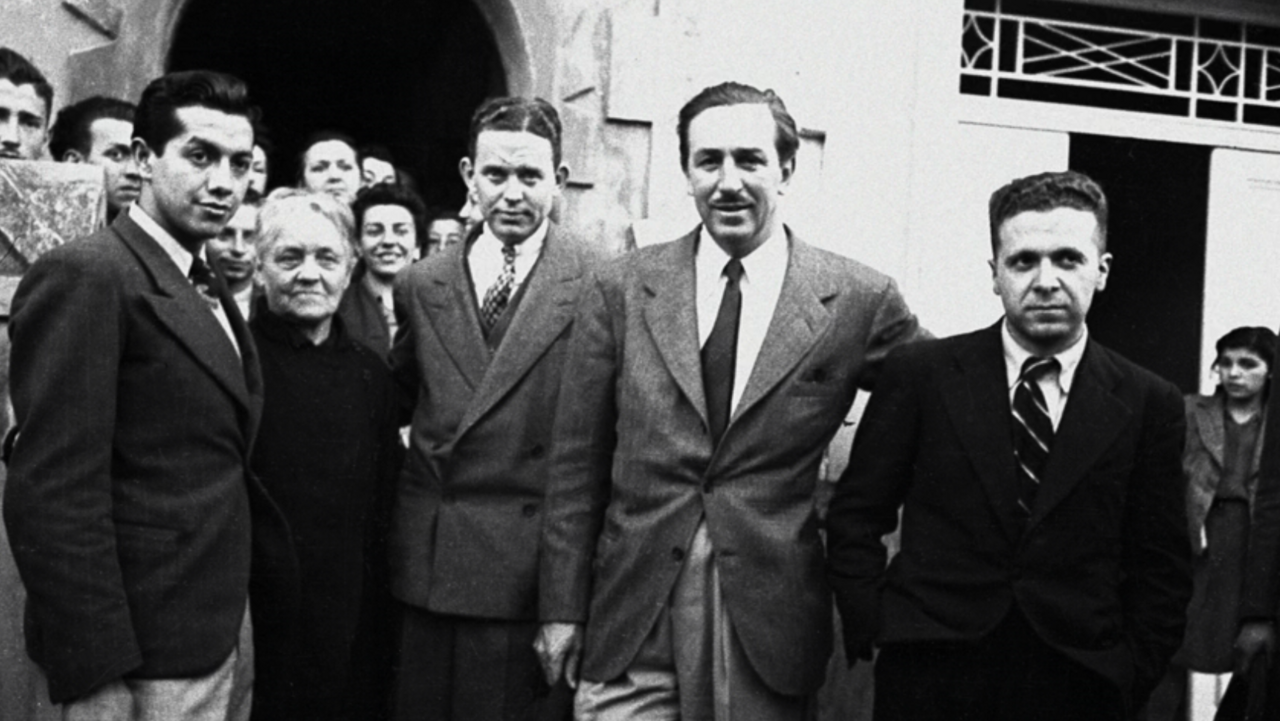 Walt Disney, centre, with his brother Roy and colleagues outside the new studio
