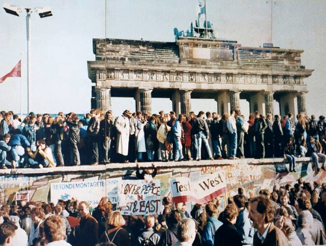 East and West Berliners crowd onto the Wall at the Brandenburg Gate