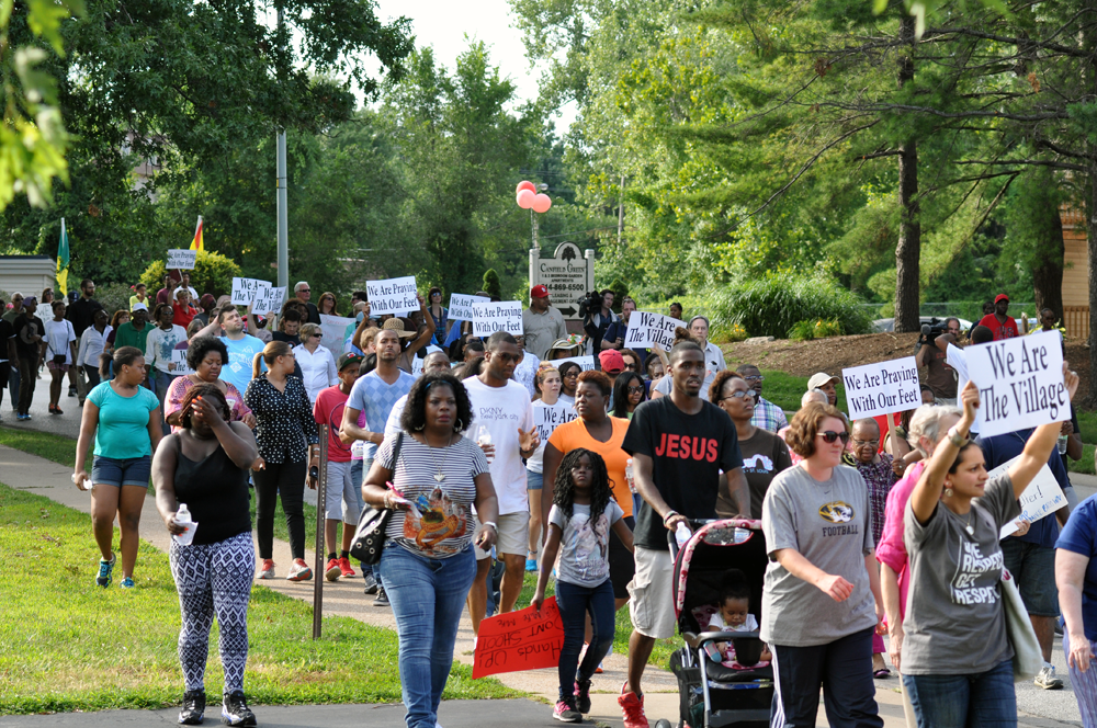 Protesters march in Ferguson following the fatal police shooting of Michael Brown