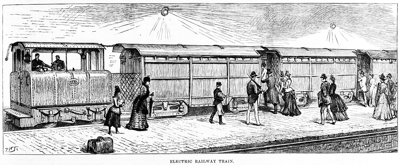 Passengers board the new electric railway train at its opening