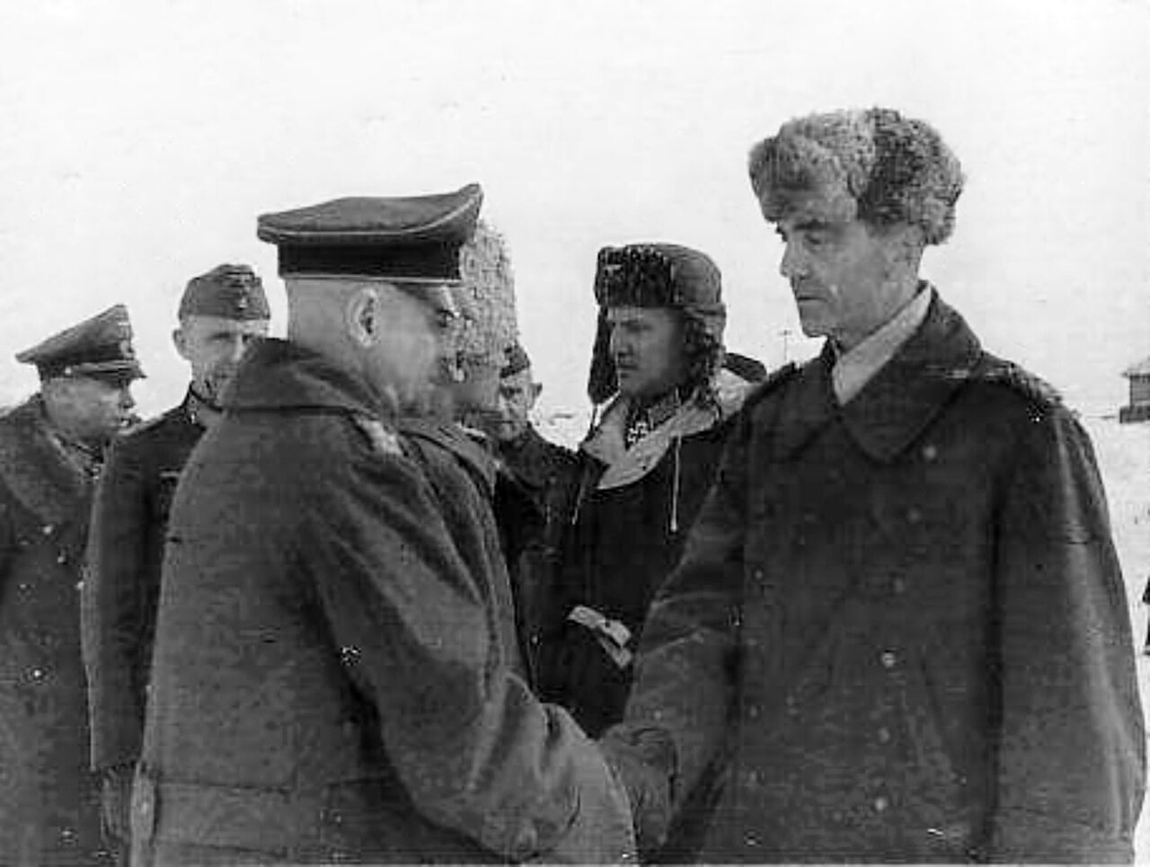 General Paulus confers with officers in the snow outside Stalingrad