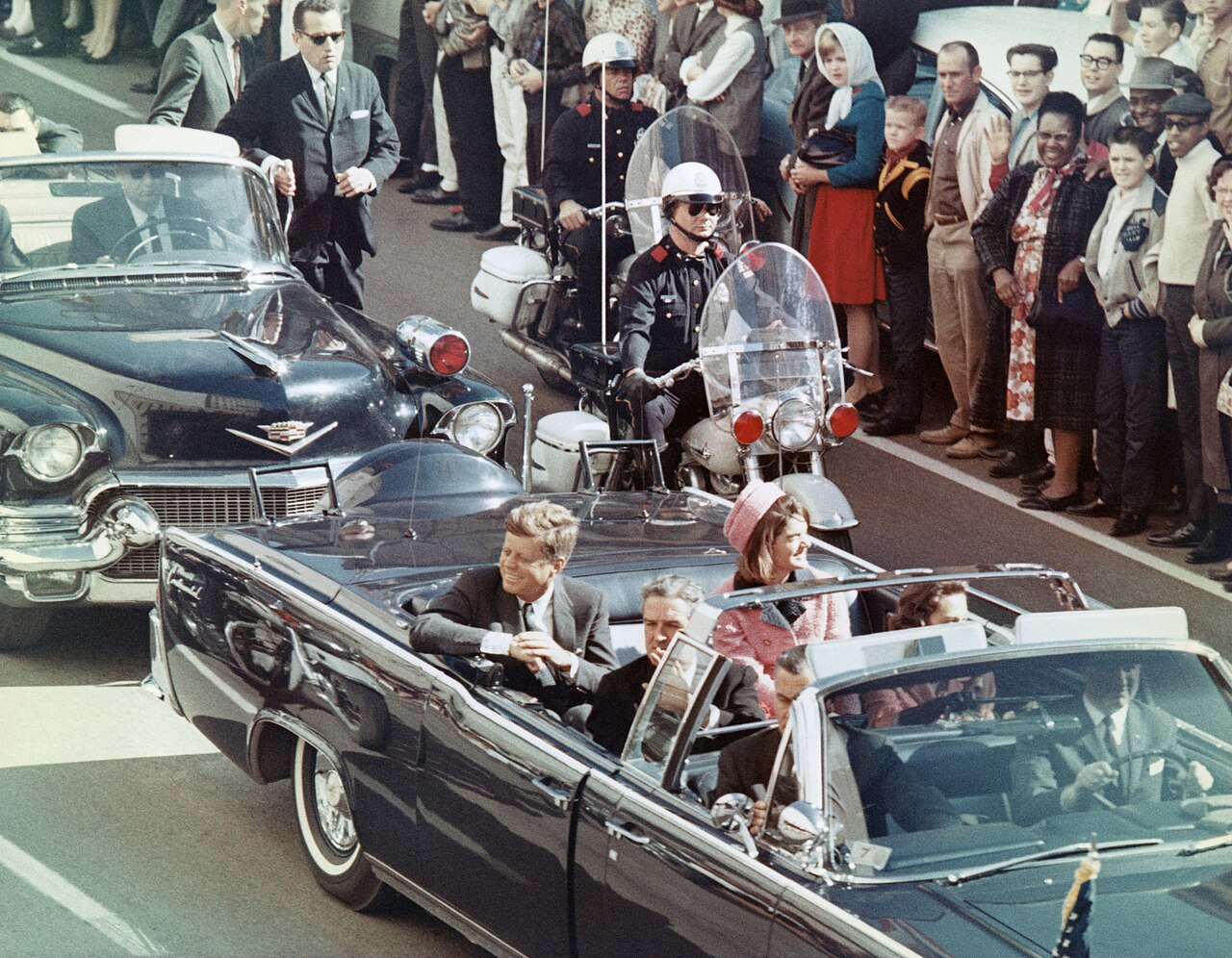 The presidential limousine moments before gunfire strikes