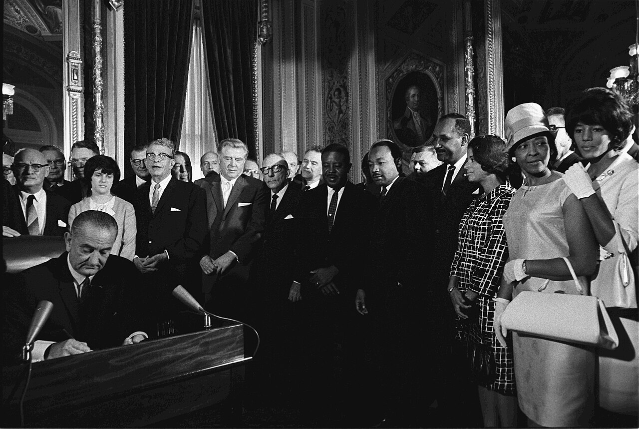 President Lyndon B. Johnson signs the Voting Rights Act into law in 1965