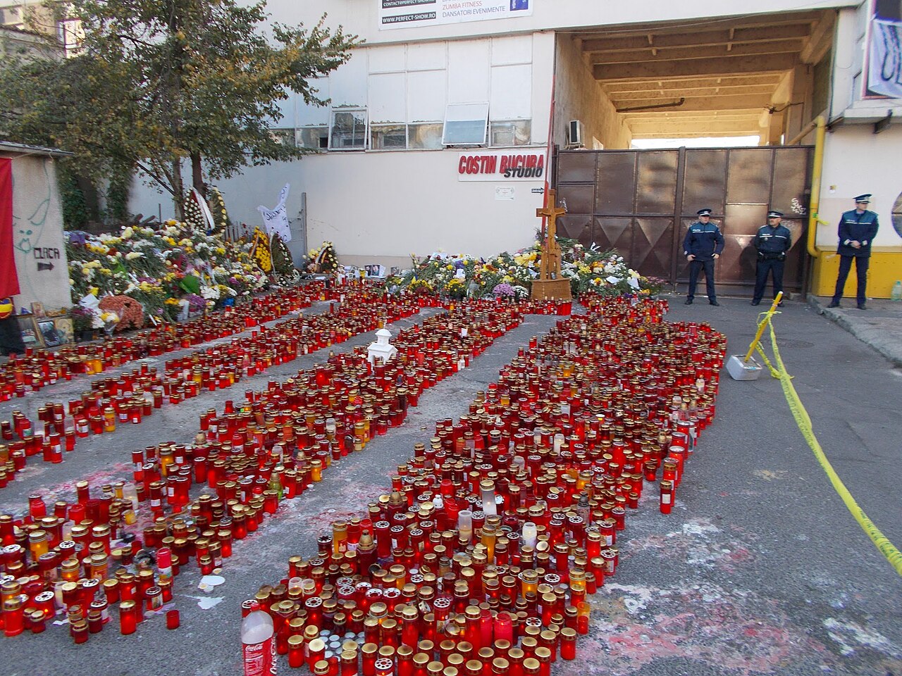 Thousands of candles cover the pavement outside the Colectiv nightclub