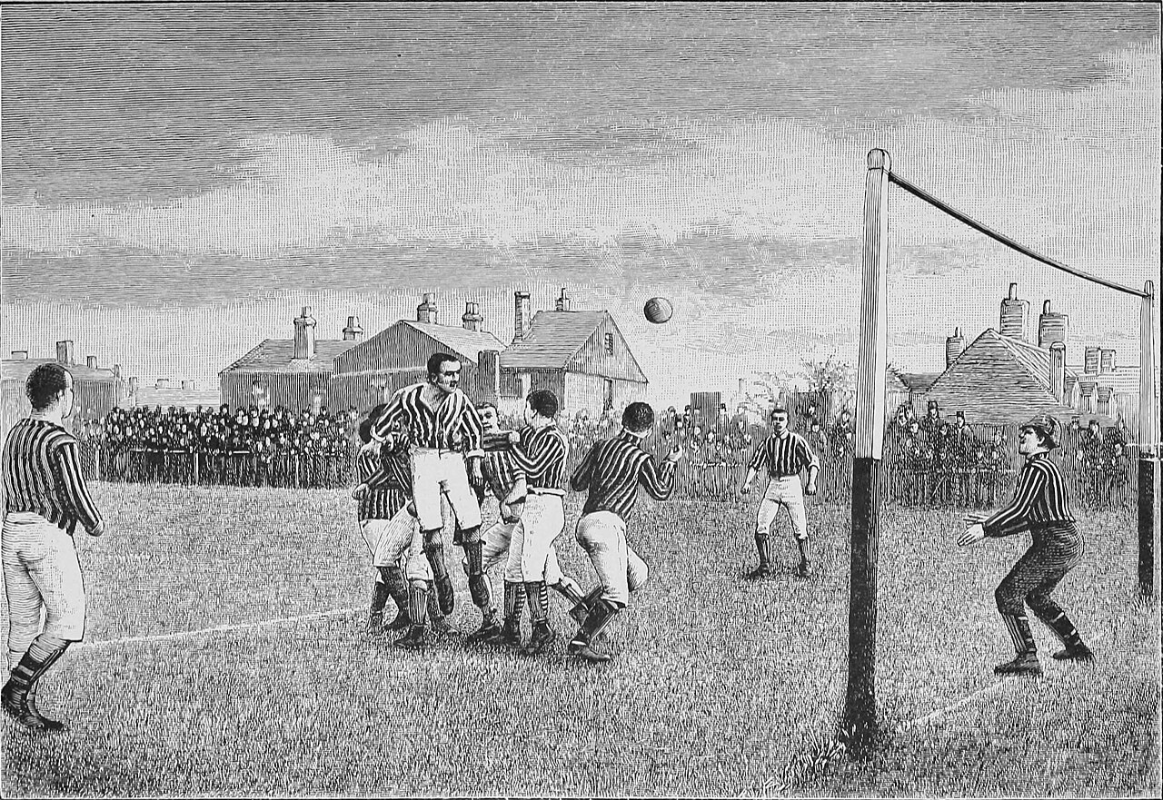 Players contest the ball near goal in an early match