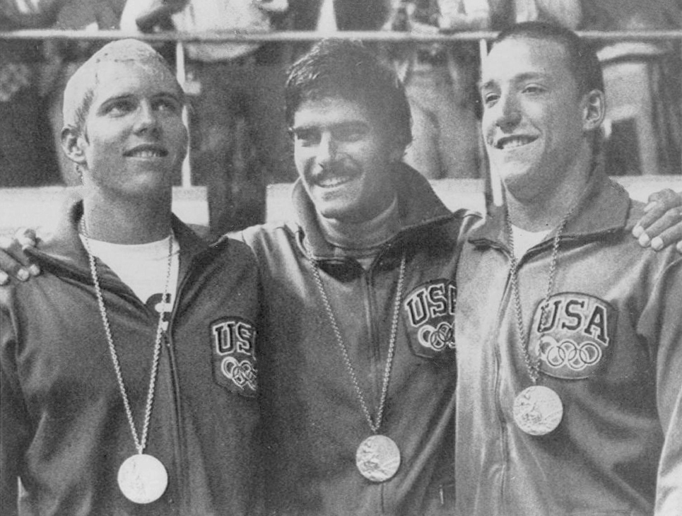 Mark Spitz stands with two teammates wearing their Olympic medals